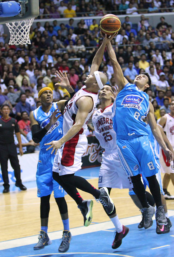 Peter June Simon of San Mig Coffee (No.8) blocks the shot of Mark Caguioa of Ginebra in this bit of action in Game 6 of the 2014 PBA Philippine Cup semifinal round at the Smart Araneta Coliseum, Monday night. Ginebra won, 94-91 to force a Game 7. (Photo by Nuki Sabio) 