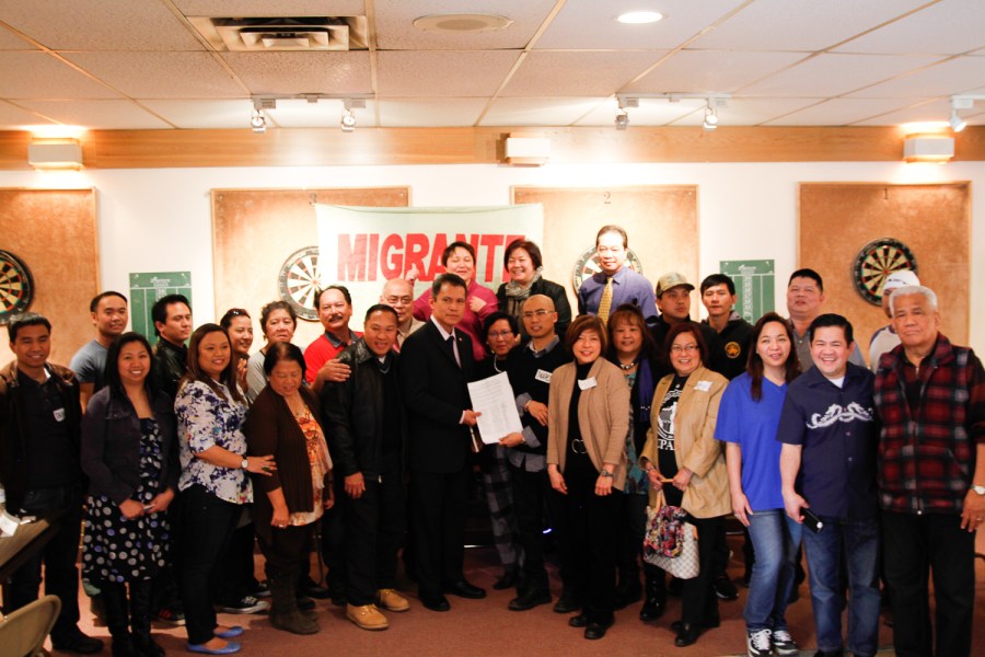 Philippine Consul General Neil Frank Ferrer (6th from left) and Migrante Canada secretary-general Marco Luciano hold Migrante Alberta's Position Paper for an Alberta-based Consular Office during a recent gathering in Calgary. (Migrante Alberta photo)