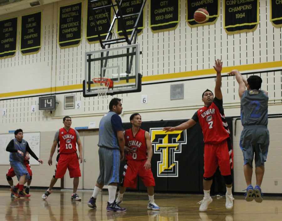 Eswar's Warren Guillen (No.7) tries to block a shooter from Greatway Financial as teammates James Saynes(No.0) and Selwyn Wagwag (No.10) wait for the next moves. Eswar prevailed in their first game of the Philippine Sport Association-Crosstown Auto Centre Spring Basketball League, 87-66, at the Holy Trinity gym in Edmonton.(Photo by Moses Billacura/pinoy edmonton news)
