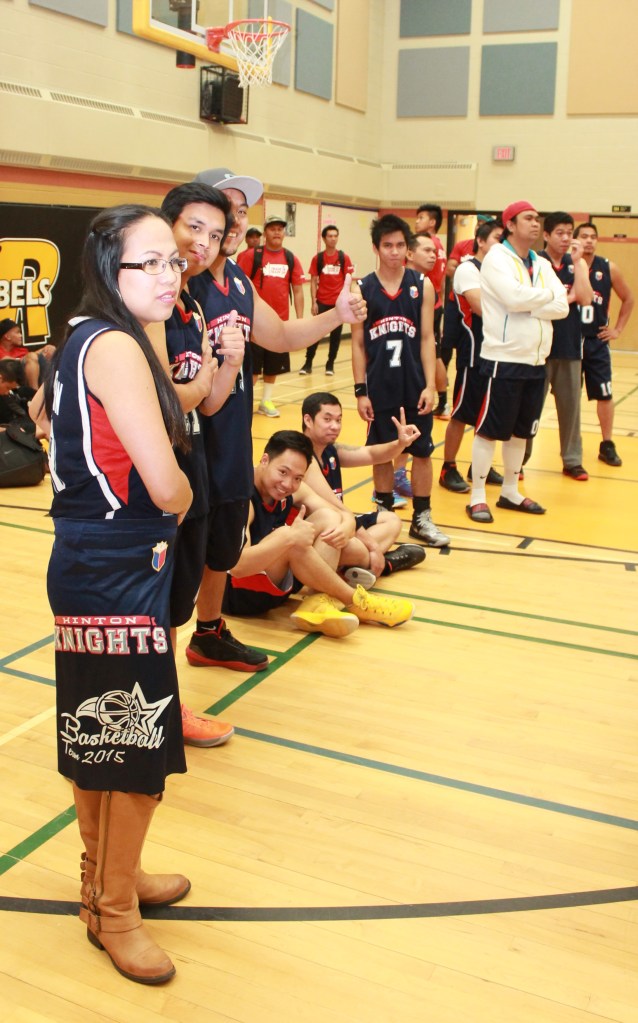 Team muse Janice Thompson with the Hinton Knights, composed mostly of temporary foreign workers.(p.e.n.)