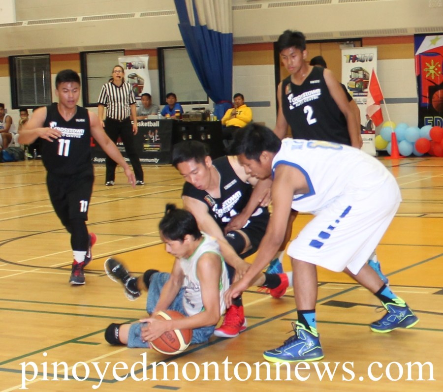 Grande Prairie's JP Cruz protects the ball from Crosstown's JR Eje in this bit of action of the 2nd Edson Filipino Inter-Town Basketball League, Sunday.(Photo by Moses Billacura/pinoy edmonton news) 