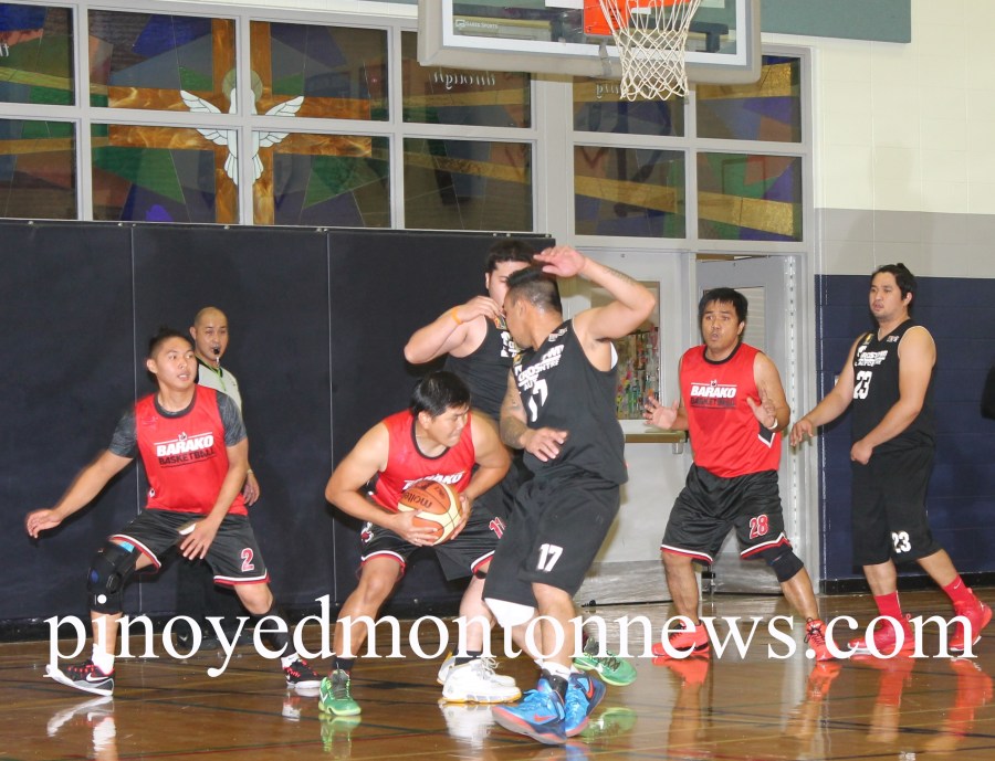 Barako's Sandy Lamigo tries to squeeze in against Alex Galang (No.17) and another guard in this bit of action of the 2015 Philippine Sport Association-Crosstown Auto Centre Fall/Winter Basketball League, Saturday, at the Father Troy Catholic School gym.(Photo by Moses Billacura/pinoy edmonton news)