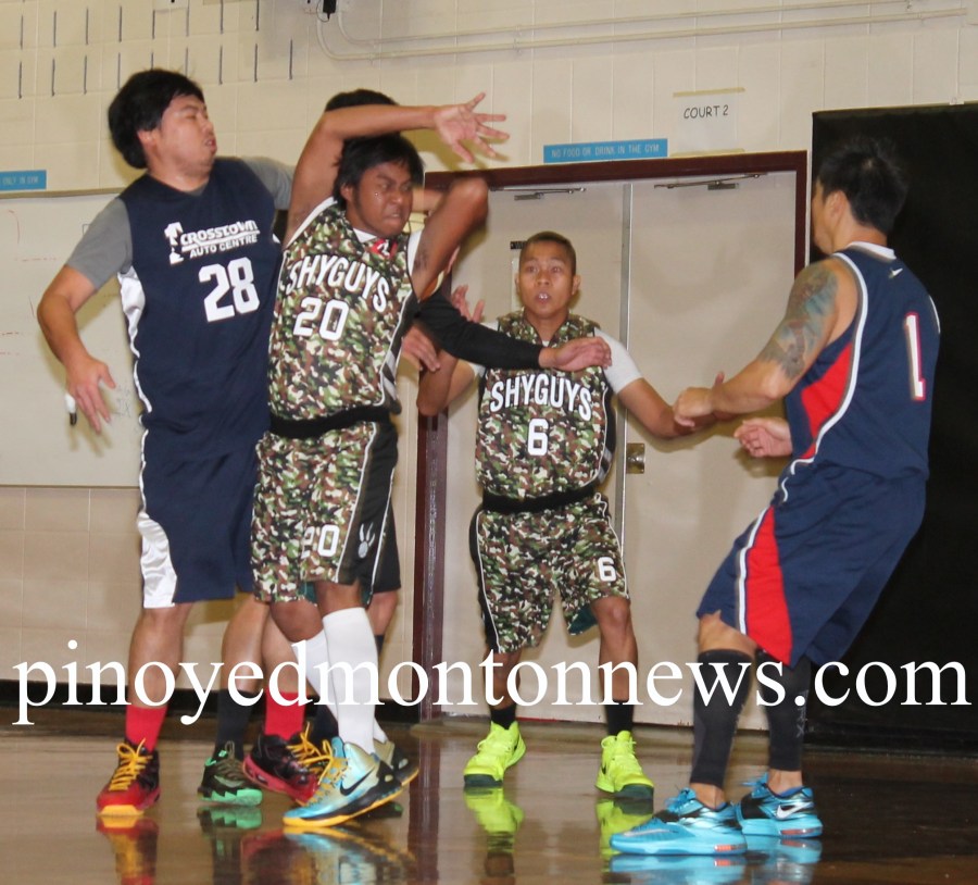 JOEL VS. JOEL.Shy Guys' Joel Batin (No.20) loses ball possession as Joel Olmo of R-Tax (No.28) grabs the ball from behind in this bit of action in the 2015 Philippine Sport Association-Crosstown Auto Fall/Winter League, Sunday, at the Holy Trinity School gym. R-Tax won, 78-66.(Photo by Moses Billacura/pinoy edmonton news)